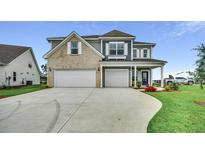 Two-story house with gray siding, brick accents, and a two-car garage at 121 Crosscut Ln, Summerville, SC 29486