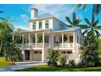 Two-story home with a metal roof, porch, and two-car garage at 6045 Honey Hole Haven, Johns Island, SC 29455