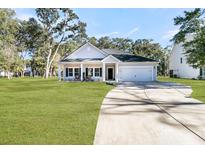 Charming one-story home with gray siding, white columns, and a two-car garage at 7078 Pumpkinseed Dr, Johns Island, SC 29455