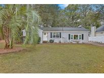 Charming gray house with white trim, landscaping, and a spacious yard at 1215 Taliaferro Ave, Charleston, SC 29412