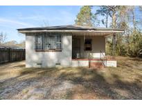 Front view of a small bungalow with a porch and security bars on the windows at 1779 Snowden Rd, Mount Pleasant, SC 29464