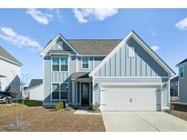 Two-story home with blue siding, white trim, and a two-car garage at 467 Eagleview Drive, Moncks Corner, SC 29461