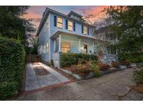 Charming two-story light blue house with front porch and landscaped yard at 11 Perry St, Charleston, SC 29403