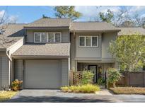 Attractive 2-story townhome with gray siding, a double garage, and landscaping at 14 Wappoo Creek Pl, Charleston, SC 29412