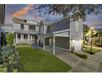 Gray two-story house with a covered carport and manicured lawn at 1615 Paradise Lake Dr, Mount Pleasant, SC 29464