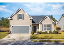 Tan house with gray shutters and a two-car garage at 176 Gaslight Blvd, Summerville, SC 29483