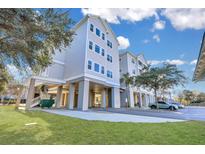 Gray building exterior with parking and landscaping at 1984 Folly Rd # B214, Charleston, SC 29412