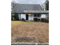 White house with gray roof, small front yard, and blue door at 208 Horseshoe Dr, Goose Creek, SC 29445