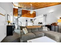 Cozy living room with spiral staircase, vaulted ceiling, and comfy seating at 279 Driftwood Ln, Edisto Beach, SC 29438