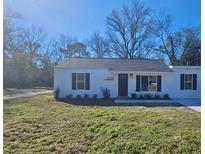 Newly constructed home with white siding, black shutters, and a landscaped lawn at 3109-3113 Matipan Ave, North Charleston, SC 29405