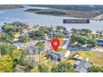 Aerial view of a charming house with a spacious yard near the Stono River at 3552 Old Ferry Rd, Johns Island, SC 29455