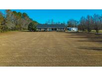 Ranch home with large yard, detached garage, and spacious driveway at 534 Farmers Market Rd, Saint George, SC 29477