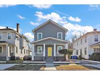 Two-story gray house with a yellow door, front porch, and well-manicured lawn at 55 Maple St, Charleston, SC 29403