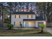 Charming two-story house with a gray door and manicured lawn at 71 Peppertree Ln, North Charleston, SC 29420