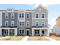 Three-story townhome with gray siding, white trim, and a front porch at 809 Recess Pointe Dr # 51, Moncks Corner, SC 29461