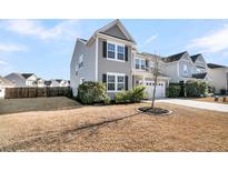 Two-story house with gray siding, white trim, and a two-car garage at 9736 Black Willow Ln, Ladson, SC 29456