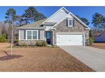 One-story home with stone accents and a two-car garage at 1040 Wading Point Blvd, Huger, SC 29450