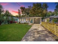 Charming one-story home with a freshly landscaped lawn and modern fence at 1210 Pepper St, Hanahan, SC 29410