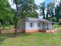Newly renovated home with a spacious yard and wooden deck at 159 Hayes Ln, Williams, SC 29493
