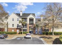 Two-story apartment building with brick and siding exterior, ample parking, and landscaping at 2011 N Highway 17 # 1900P, Mount Pleasant, SC 29466
