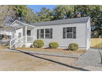 Charming white house with gray roof, shutters, and a front porch at 2229 Suffolk St, North Charleston, SC 29405