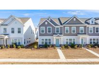 Two-story townhouses with gray and white siding, landscaping, and walkways at 240 Godwit Dr, Summerville, SC 29486