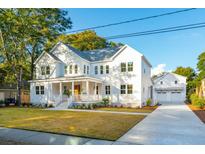 Two story home with white siding, detached garage, and a landscaped lawn at 362 6Th Ave, Mount Pleasant, SC 29464