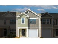 Two-story townhome with light green and gray siding, white garage door, and landscaping at 520 Golden Embers Way, Summerville, SC 29486
