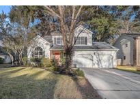 Two-story house with a two-car garage and landscaped yard at 8517 Falling Leaf Ln, North Charleston, SC 29420