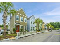 Row of colorful townhouses with white picket fences at 2964 Evening Tide Dr, Hanahan, SC 29410