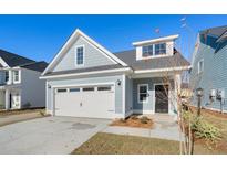 Two-story home with gray siding, two-car garage, and landscaping at 428 Grove End Rd, Moncks Corner, SC 29461