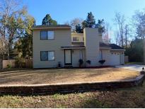 Two-story house with attached garage and landscaped yard at 111 Downing Ct, Goose Creek, SC 29445