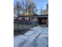 Brick ranch home with carport and fenced yard at 111 Elmora Ave, Goose Creek, SC 29445