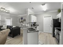 Modern kitchen with stainless steel appliances and granite countertops at 1445 Cambridge Lakes Dr # 206, Mount Pleasant, SC 29464