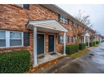 Brick building exterior with two apartment entrances and landscaping at 1836 Mepkin Rd # D5, Charleston, SC 29407