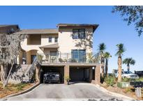 Two-story townhome with attached garage and deck, offering charming curb appeal at 1915 Marsh Oak Ln, Seabrook Island, SC 29455