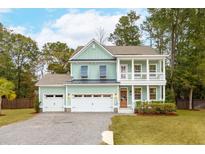 Two-story light green house with white columns, double garage, and landscaping at 2155 Provolone Ln, Johns Island, SC 29455