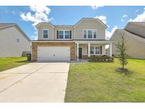 Two-story house with stone accents, a front porch, and a well-maintained lawn at 238 Wathen Dr, Goose Creek, SC 29445