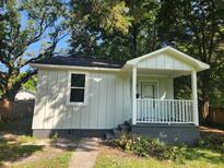 Charming cottage with a white porch and gray brick base at 2664 Hull St, North Charleston, SC 29405
