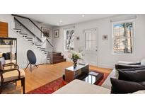 Bright living room with hardwood floors, modern furniture, and a stylish rug at 301 Broad St # 1, Charleston, SC 29401