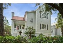 Two-story house with gray siding, red roof, and a front porch at 4021 Bridle Dr, Johns Island, SC 29455