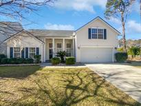 Two-story house with a two car garage and manicured lawn at 606 Pointe Of Oaks Rd, Summerville, SC 29485