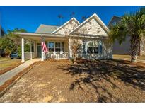 Charming one-story home with front porch and American flag at 104 Pavilion St, Summerville, SC 29483