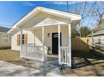 Charming yellow cottage with white porch and landscaping at 1948 Burton Ln, North Charleston, SC 29405