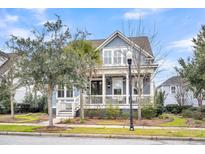Charming two-story home with front porch and landscaped yard at 2433 Louisville St, Charleston, SC 29492