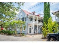 Charming two-story home with a metal roof and a wrap-around porch at 27 Chapel St, Charleston, SC 29403