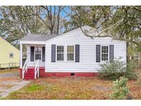 Charming white house with red brick steps, gray shutters, and a well-maintained lawn at 2793 Ranger Dr, North Charleston, SC 29405