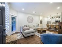 Open living room with light walls, hardwood floors, and a comfortable sectional sofa at 400 Bucksley Ln # 103, Daniel Island, SC 29492