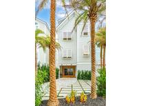 Two-story beach home with white siding, shutters, and a paved driveway at 58 Grand Pavilion Blvd, Isle of Palms, SC 29451