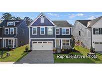 Two-story home with gray siding, white trim, and a two-car garage at 1013 Marsh Harrier Dr # Cc3-3-1, Ravenel, SC 29470